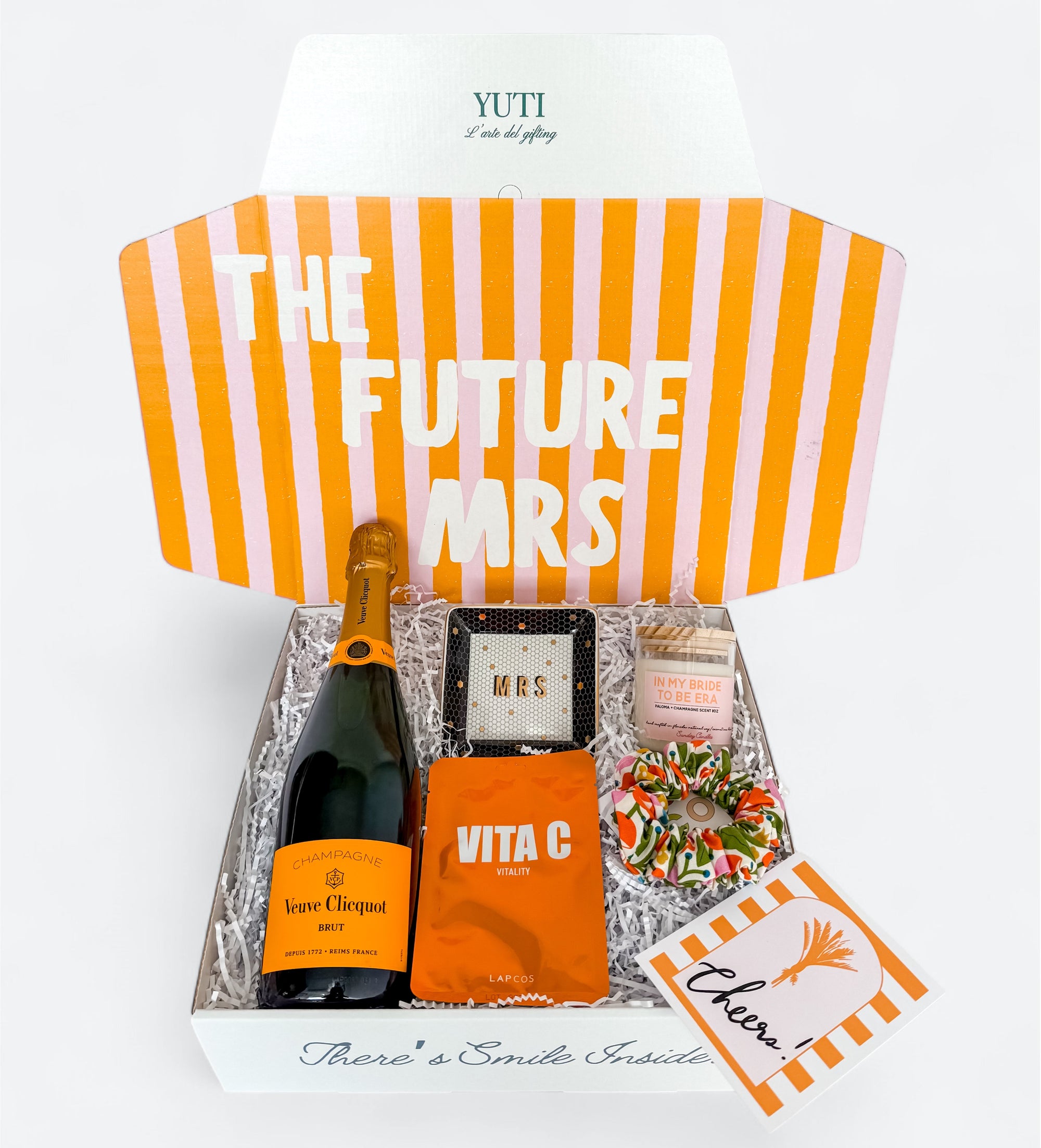 Gift basket for the future Mrs. with champagne, snacks, and a card on a white background.